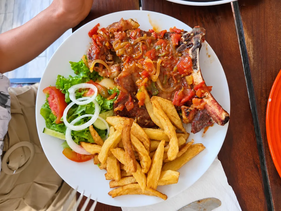 A Cafe Zambezi grilled meal with golden chips and a fresh side salad